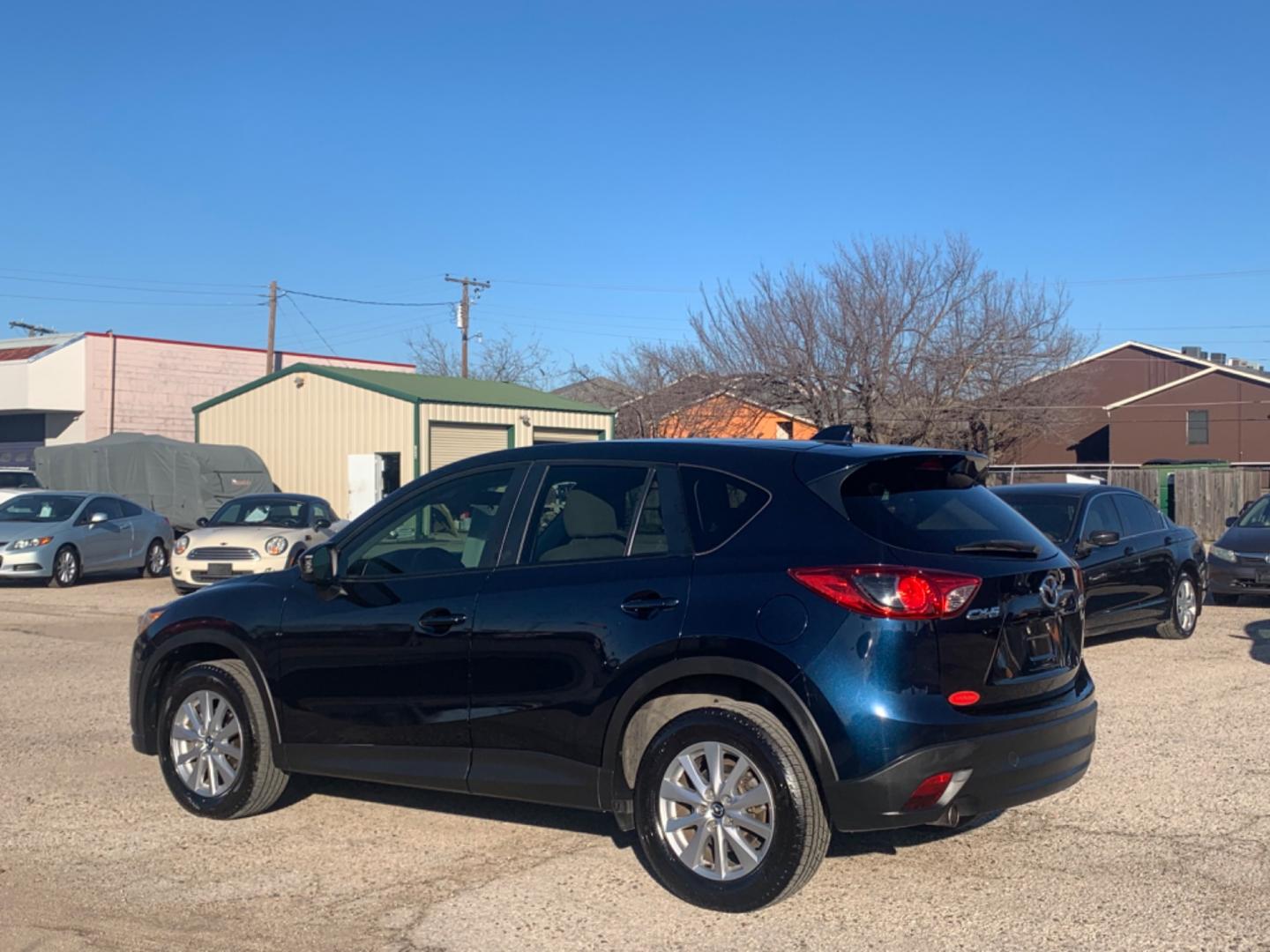 2014 Blue /Tan Mazda CX-5 Touring (JM3KE2CY1E0) with an 2.5L L4 DOHC 16V engine, Automatic transmission, located at 1830 North Belt Line Road, Irving, TX, 75061, (469) 524-0199, 32.834373, -96.993584 - Photo#4